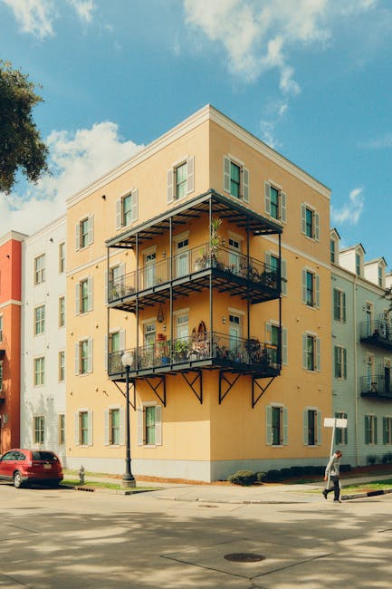 Colorful New Orleans apartment with iron balconies and street view