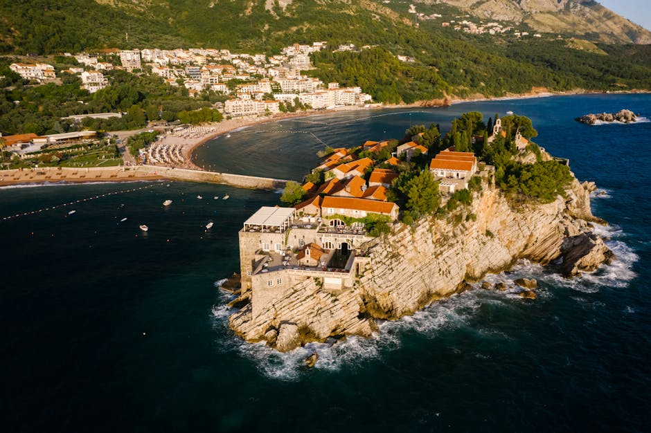 Stunning aerial shot of Aman Sveti Stefan luxury resort on a rocky islet in Montenegro.