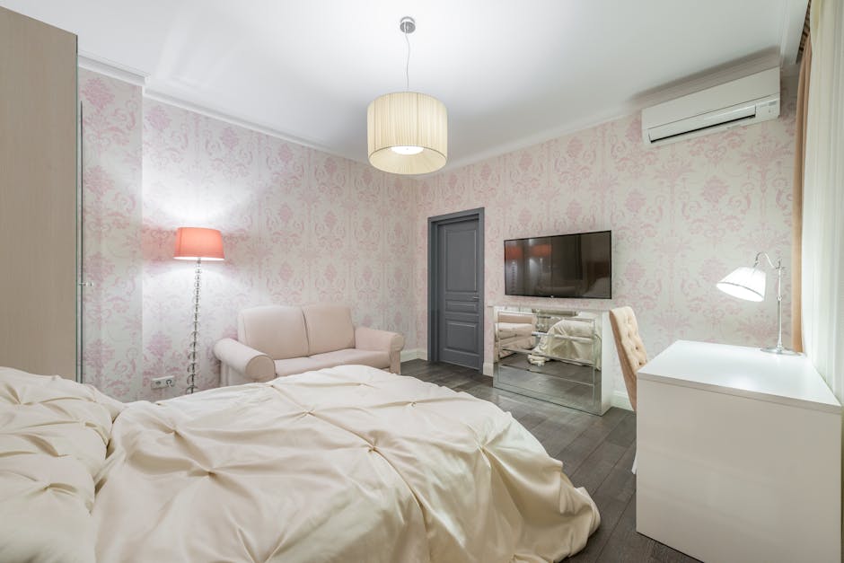 A stylish modern bedroom featuring a comfortable bed, sleek decor, and a wall-mounted TV for a relaxing ambiance.